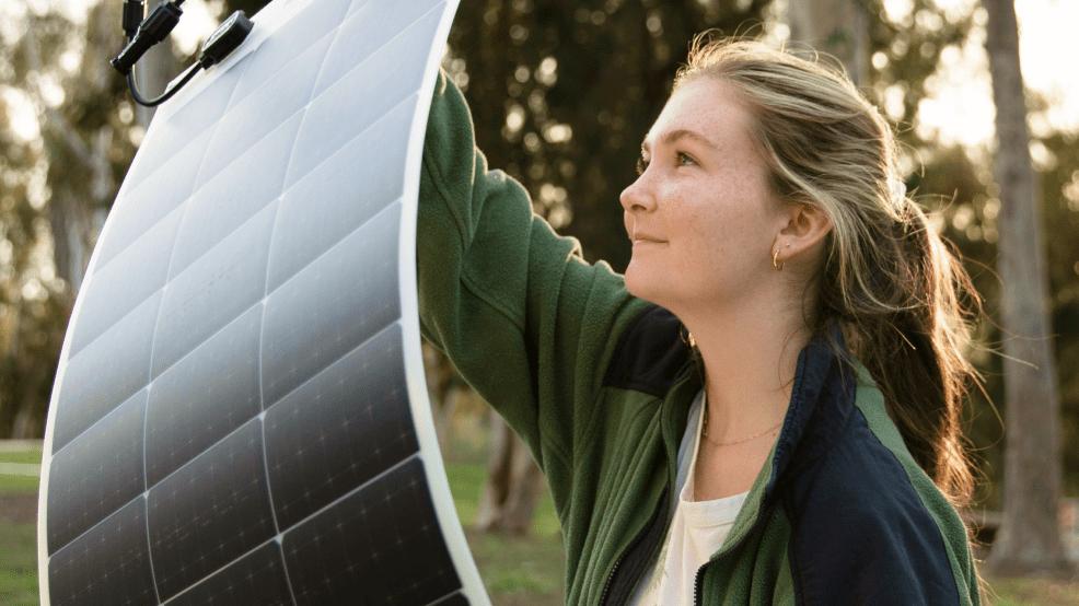 Woman holding a flexible solar panel